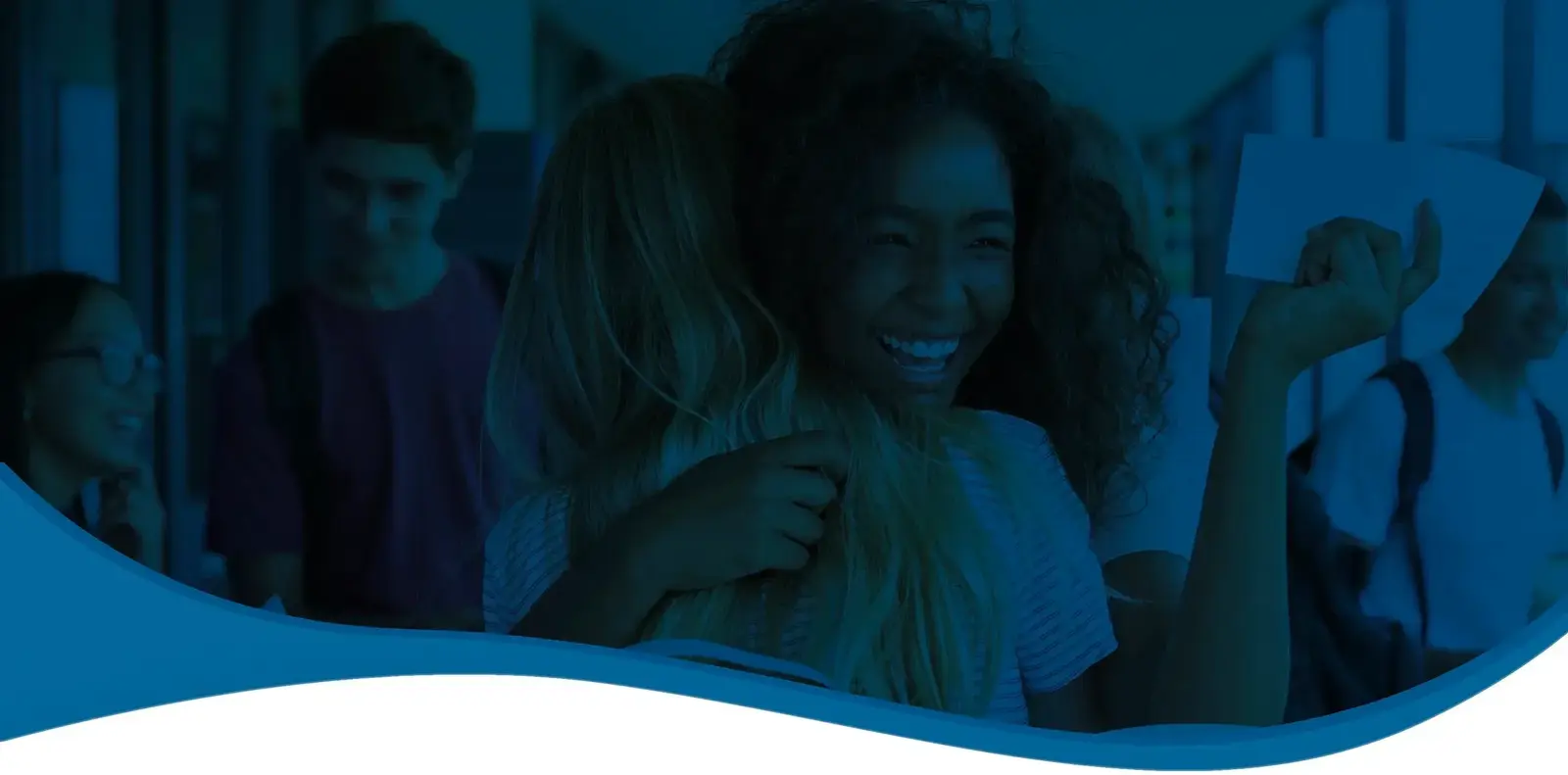 Smiling students laughing together in a school hallway, one holding a sheet of paper, under a blue overlay