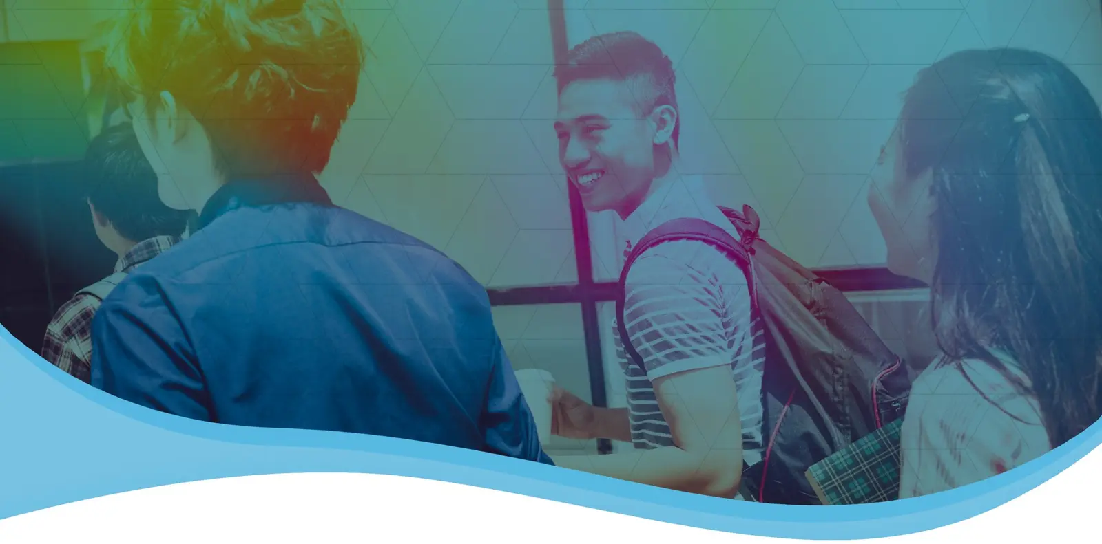 Students with backpacks chatting and smiling in a school hallway