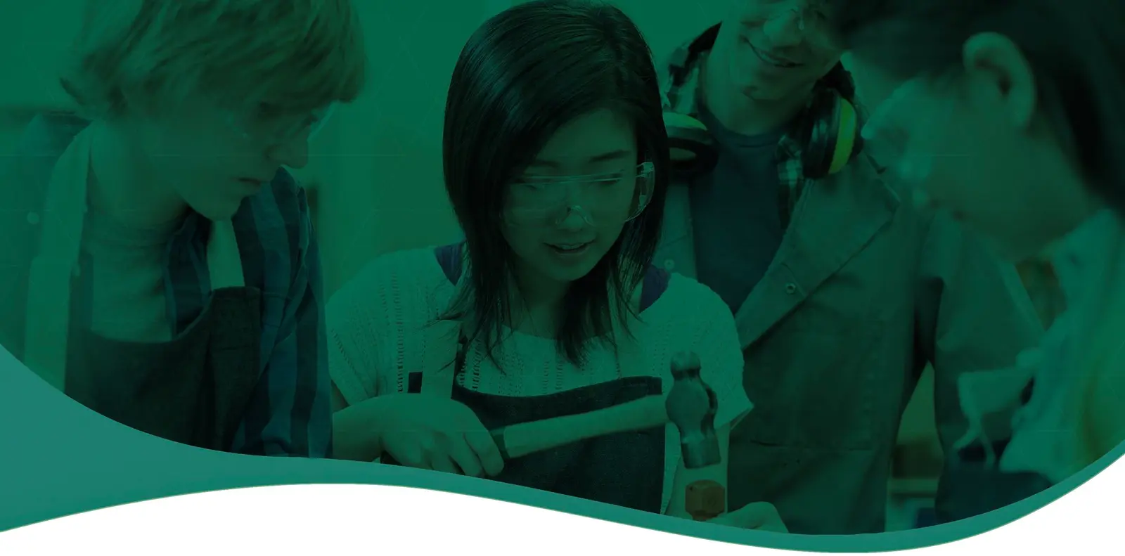 Students gathered around a workbench watching a girl hammer a piece of wood, with a green overlay