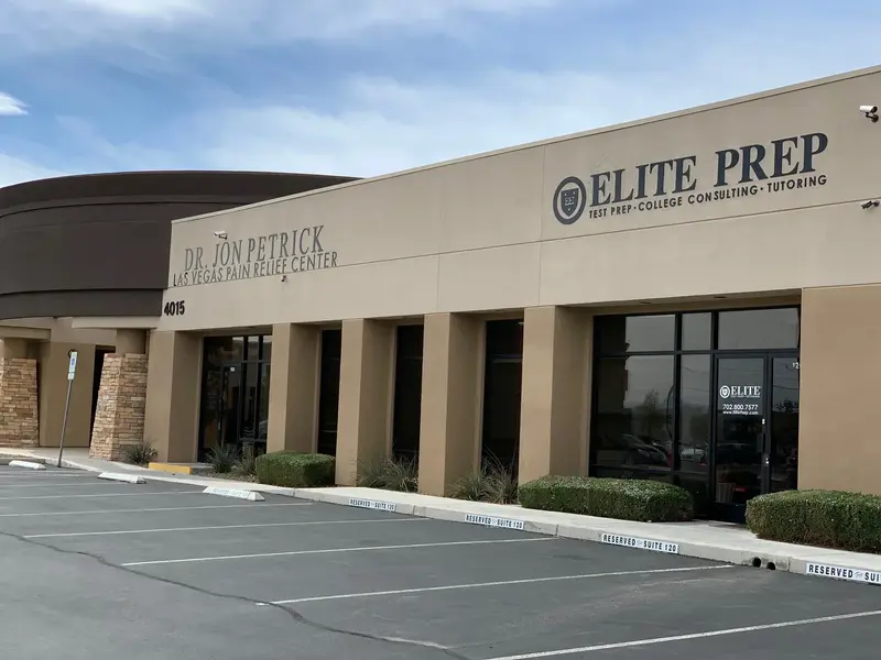 Tan single-story commercial building with "Elite Prep: Test Prep, College Consulting, Tutoring" signage and an empty parking lot.