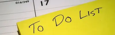 A yellow sticky note handwritten with "To Do List" resting on an open lined calendar page dated 17.