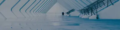 Wide, empty modern corridor with curved white arches and steel beams, tinted blue