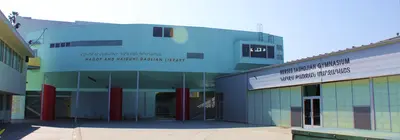 School campus buildings with signs reading "Hagop and Haiguhi Daglian Library" and "Nerses Tashdjian Gymnasium".