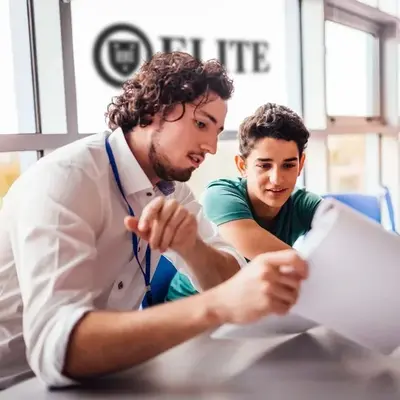 An Elite Prep tutor going over a paper with a student, the Elite sign behind them